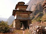 Manaslu 05 07 Ghap Kani I stopped and admired the Ghap (2110m) kani, with intricate, well-preserved paintings on the inside. A stone kani is a tall chorten in the form of an arch, the internal walls and ceiling of which are often decorated with Buddhist paintings.